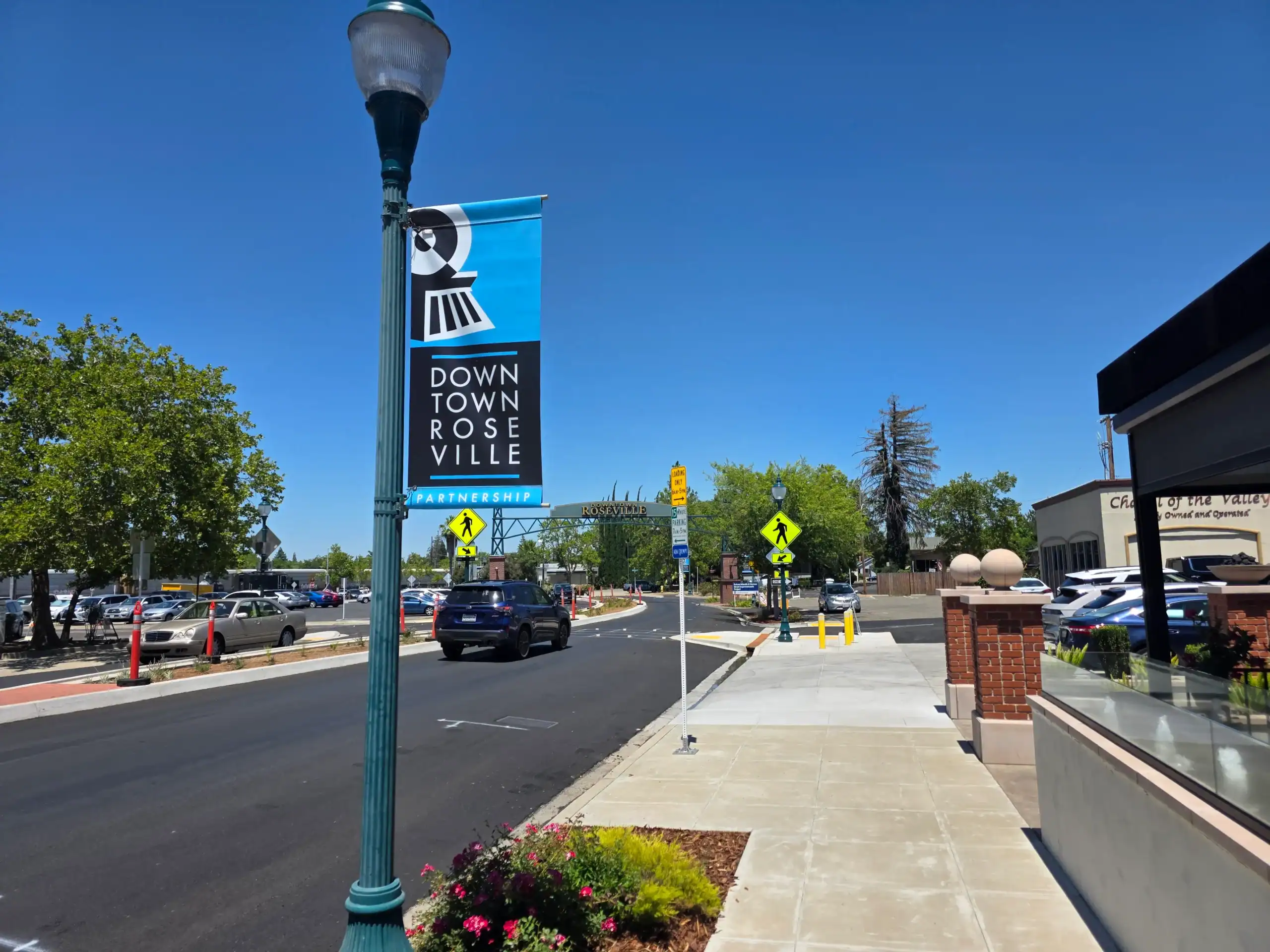 Downtown Roseville CA in middle of street Downtown Roseville with image of the "Welcome to Roseville" sign from middle of the street