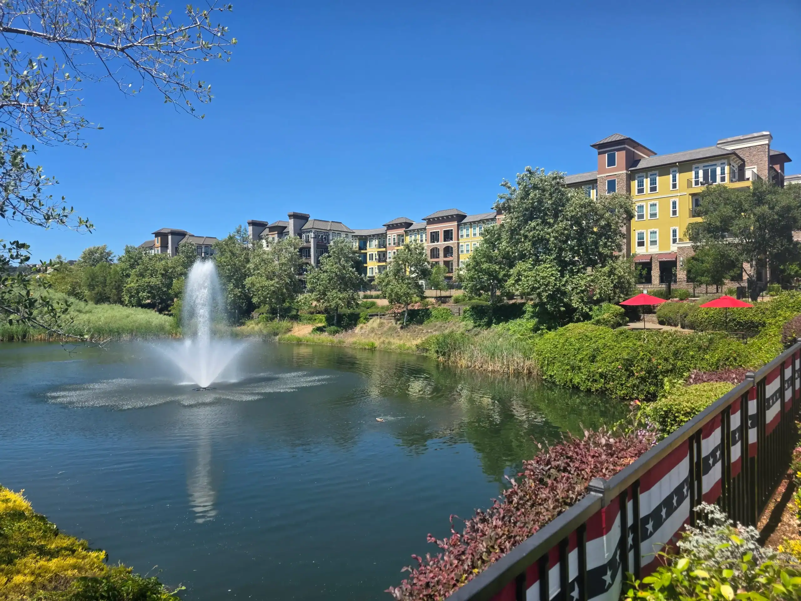 Fountain in Pond with apartments in Background El Dorado Hills Town Center Water Fountain in Pond with apartments in Background El Dorado Hills Town Center